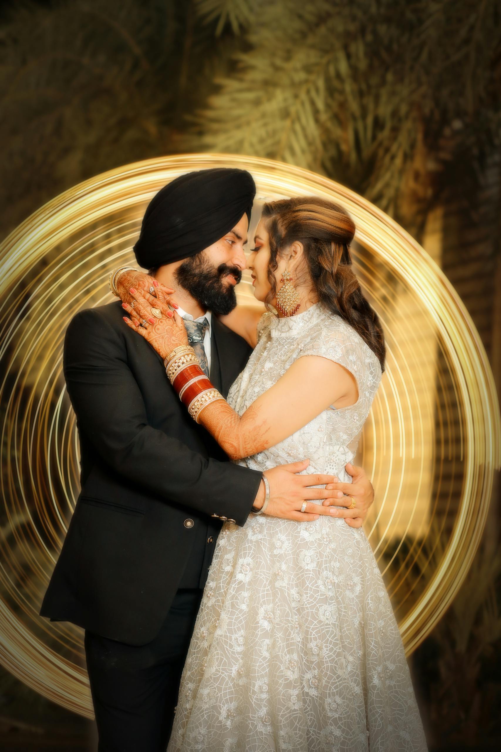 Sikh couple in love embracing at their outdoor wedding photoshoot.